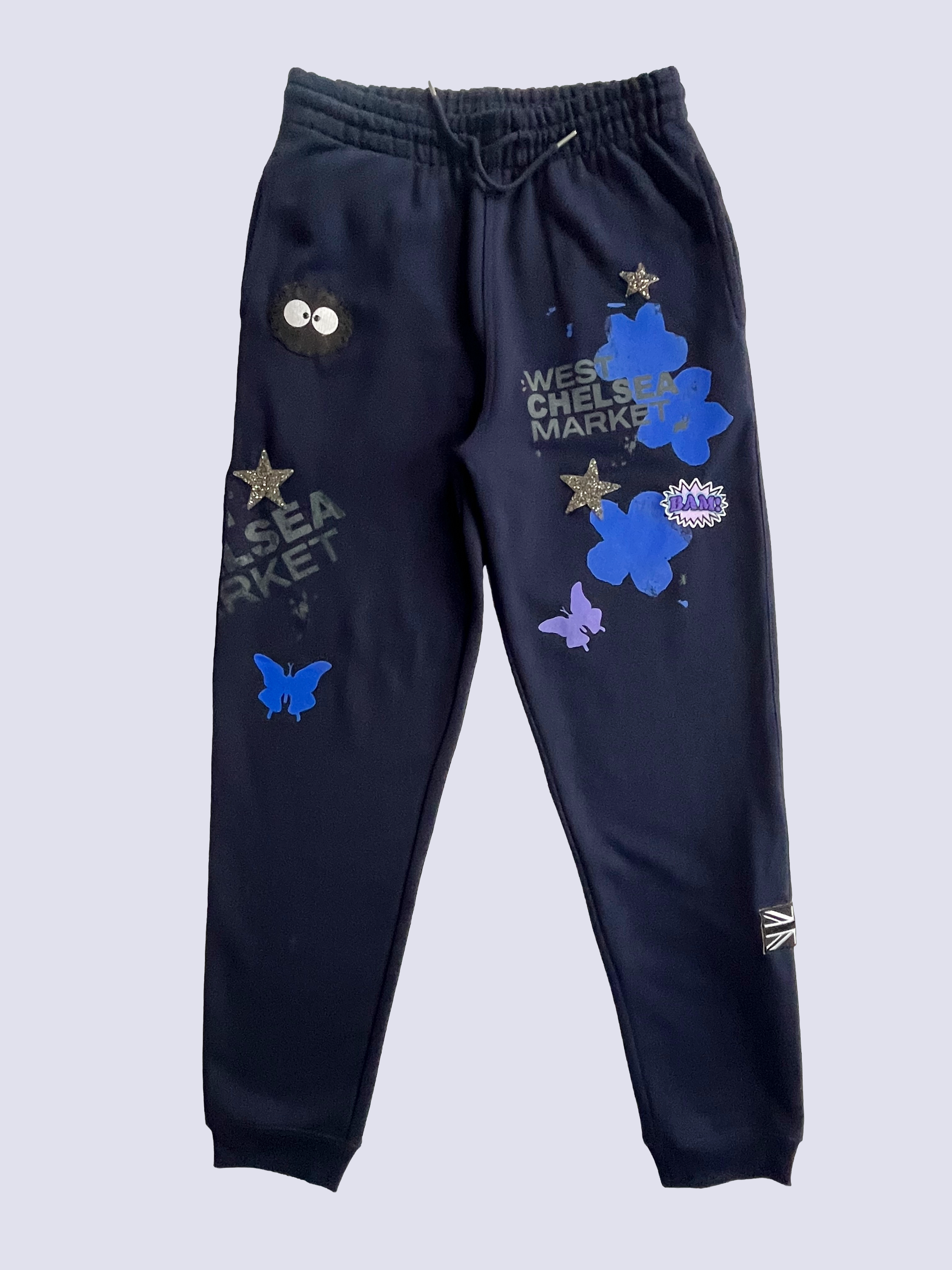 Elegant gray curtains hanging on a gold rod against a blue paneled wall with a vase and hat accent.