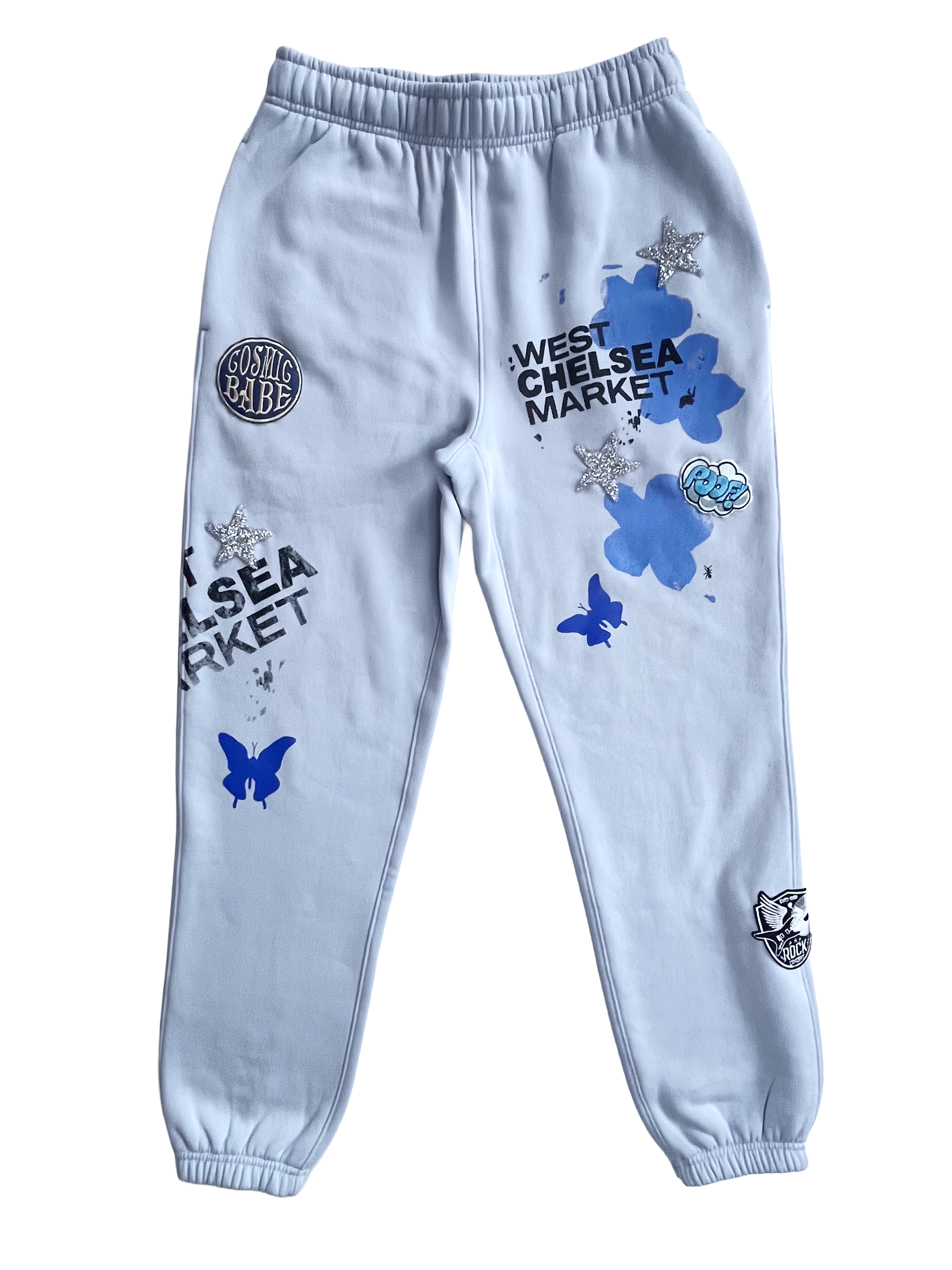 Elegant gray curtains hanging on a gold rod against a blue paneled wall with a vase and hat accent.